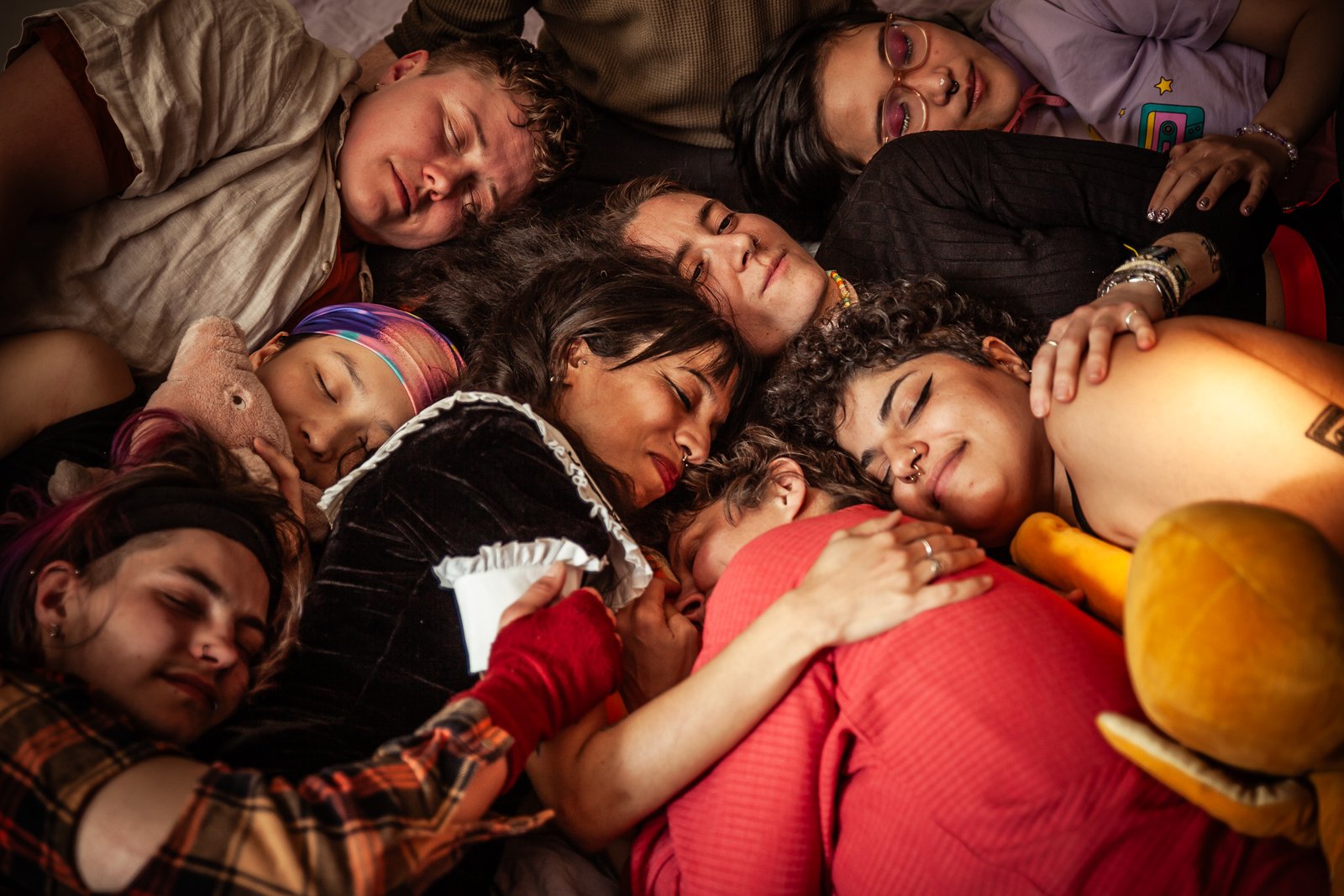 Group of tin people peacefully cuddling close together.