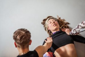 Person receiving care from two individuals.