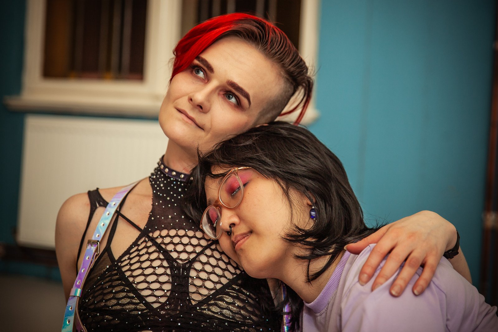 Two people are cuddling to fix their fighting Two people hugging, one with red hair