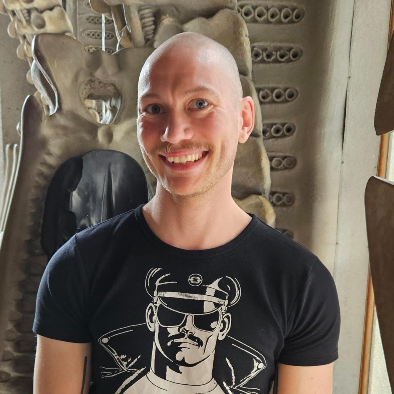Smiling person in graphic t-shirt with skeleton background.
