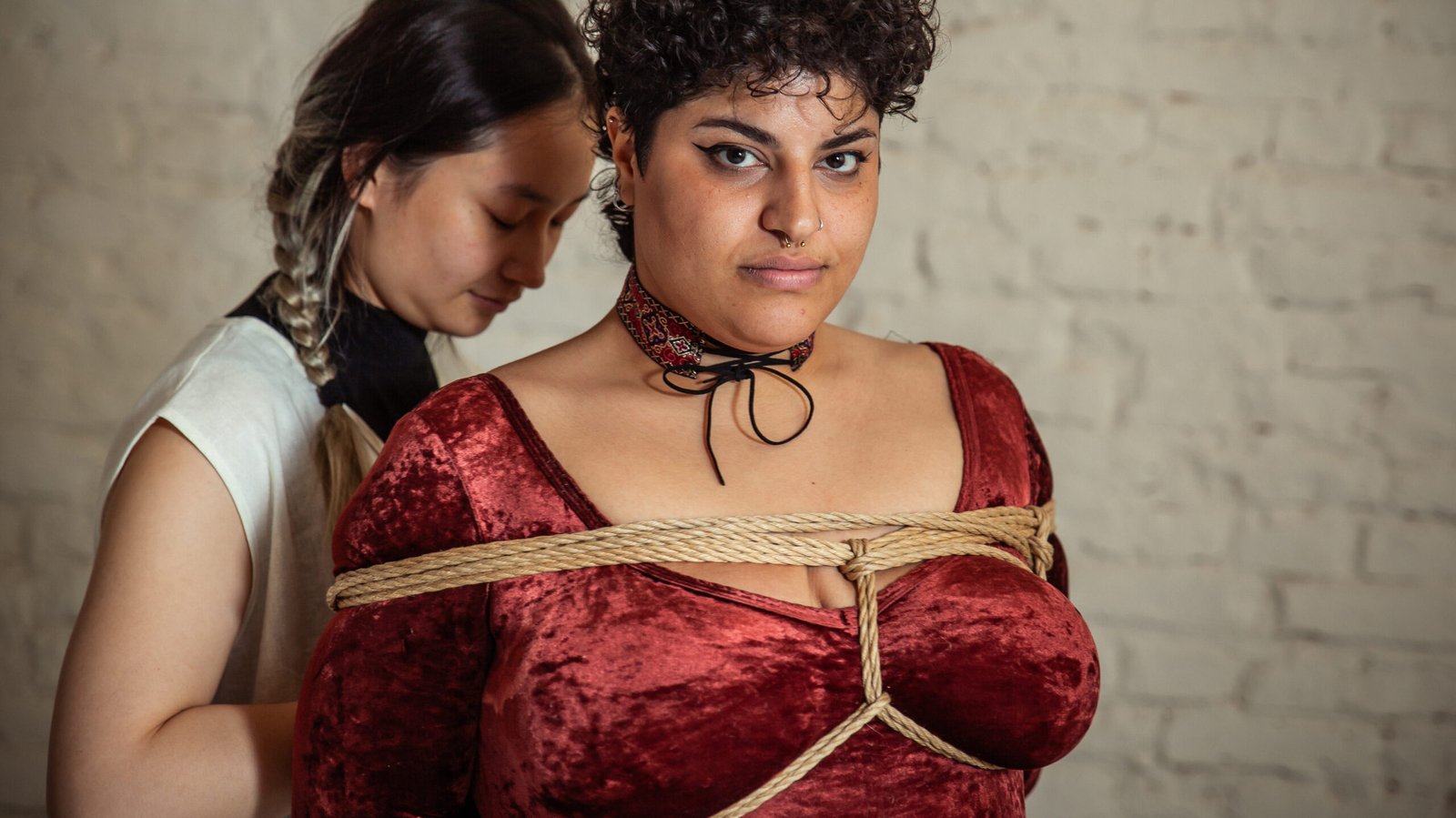 mg 6361 Person in red top, tied with decorative rope.