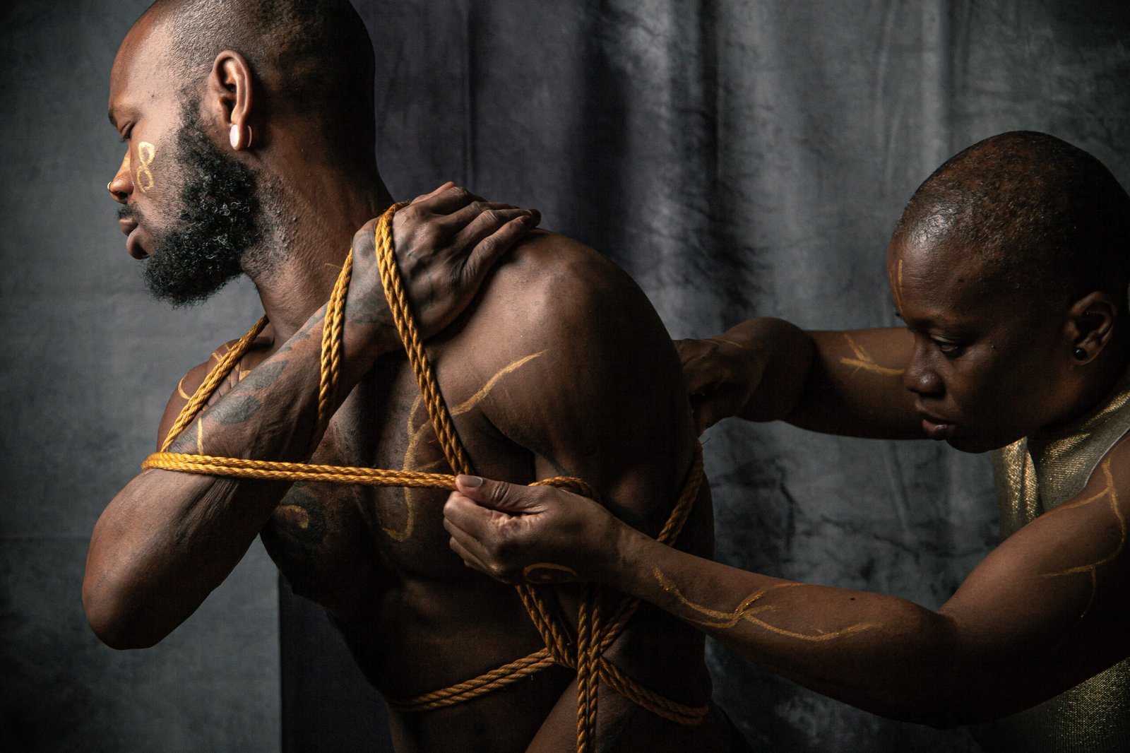 Two people in rope bondage art scene.