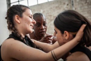 Three women engaged in intense discussion.