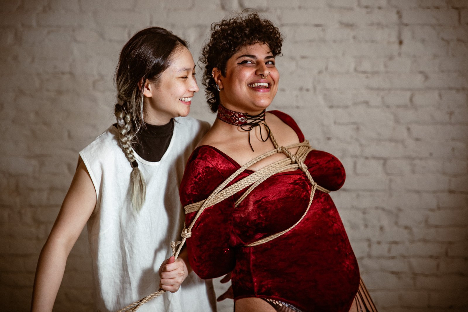 Two people engaged in rope bondage practice