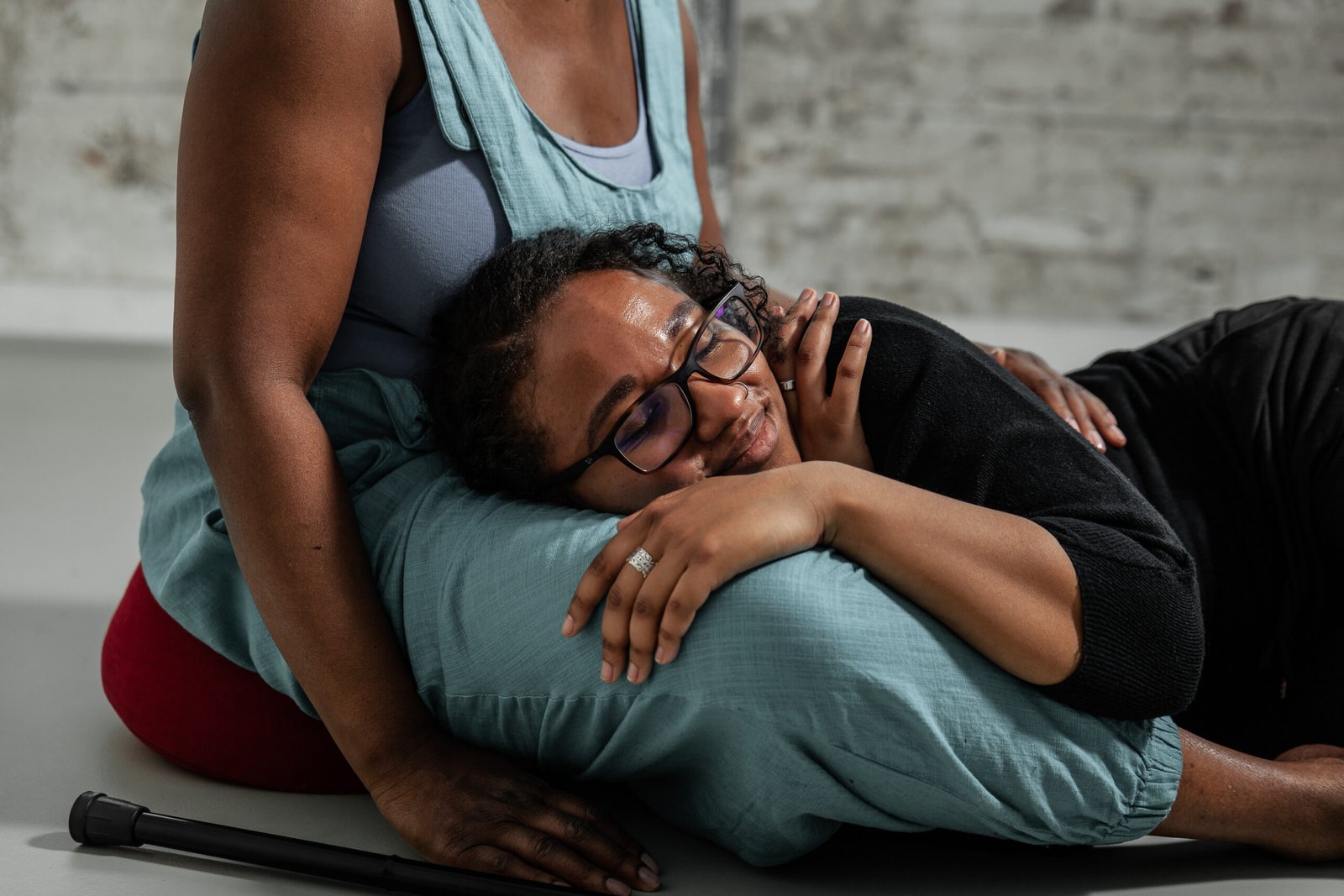 Person resting head on another's lap, feeling comforted.