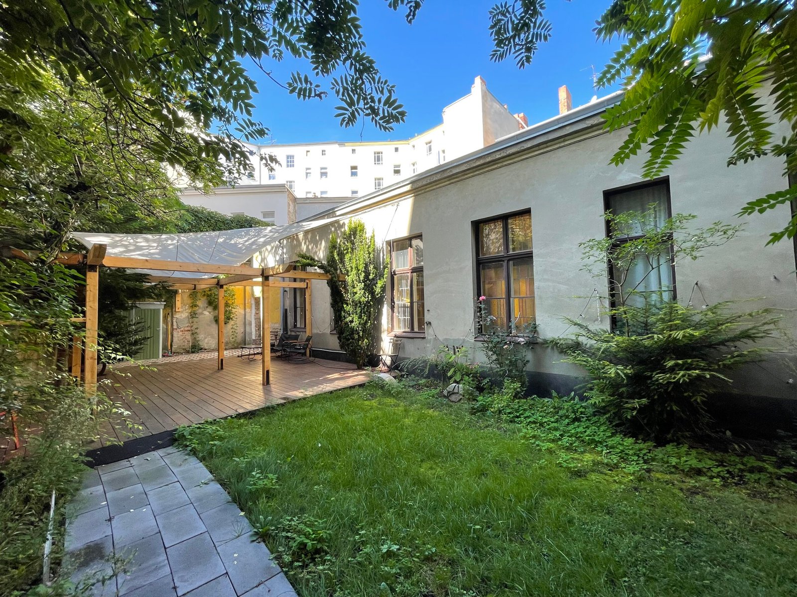 Tranquil backyard with pergola and greenery.