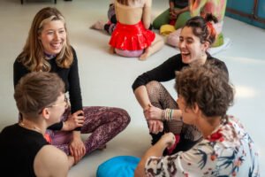 Group of people sitting and laughing together.