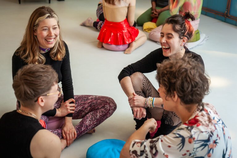 Group of people sitting and laughing together.
