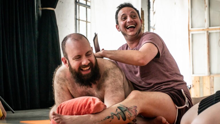 Two people laughing during relaxation activity