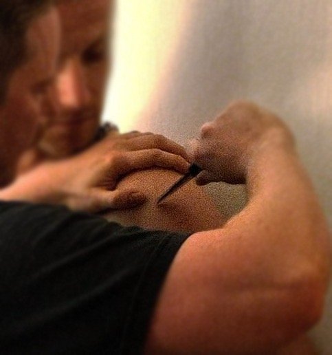 Person injecting substance into upper arm