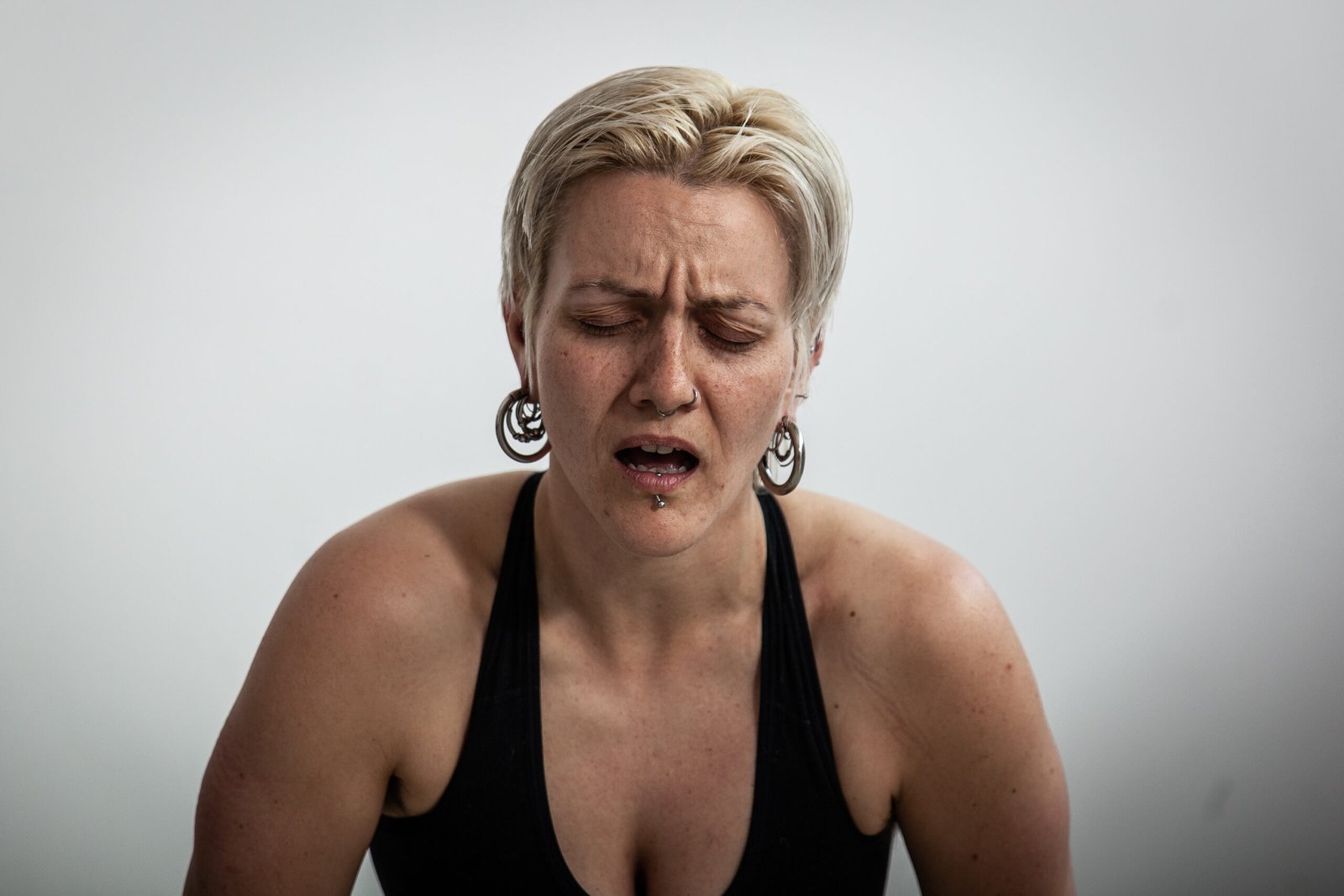 Woman with eyes closed, expressing emotion.
