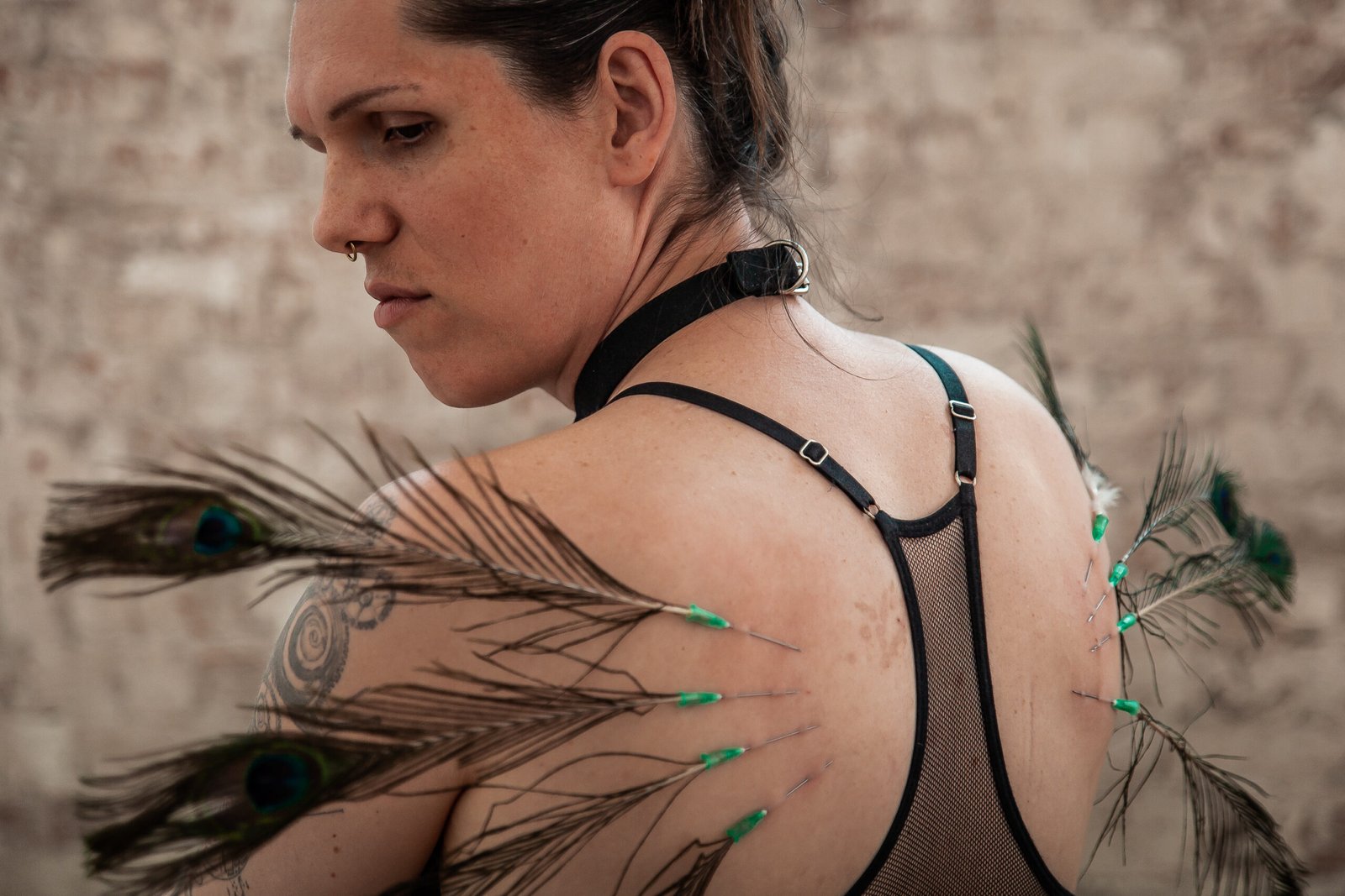 Woman with peacock feathers on her back.