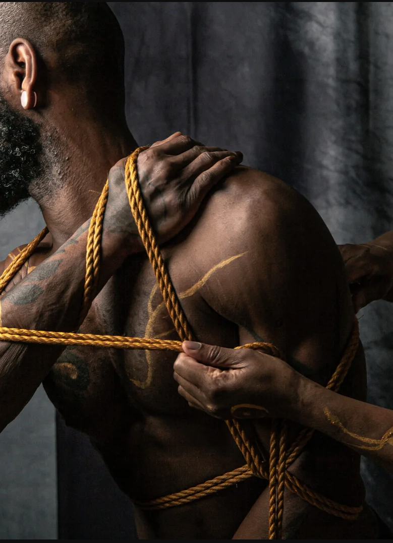 Man wrapped in golden rope artfully bound