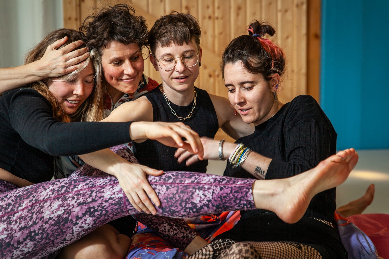Four friends laughing together indoors
