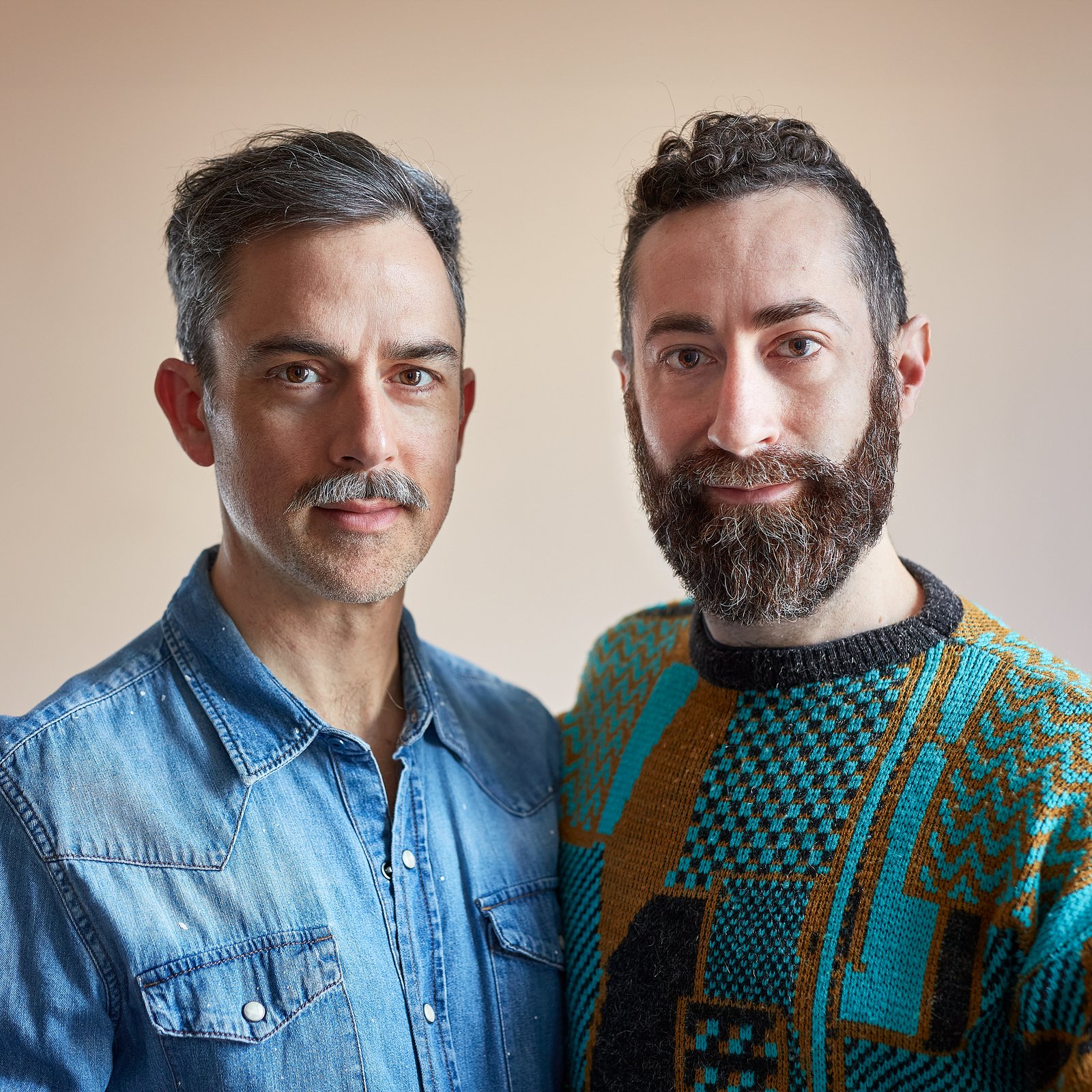 Two men posing for studio portrait