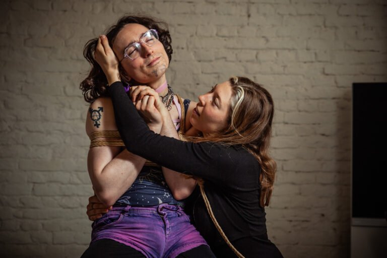 Person tied with rope embraced by partner