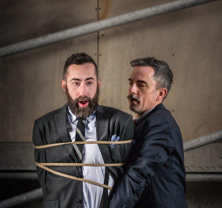 Man in suit tied with rope, restrained