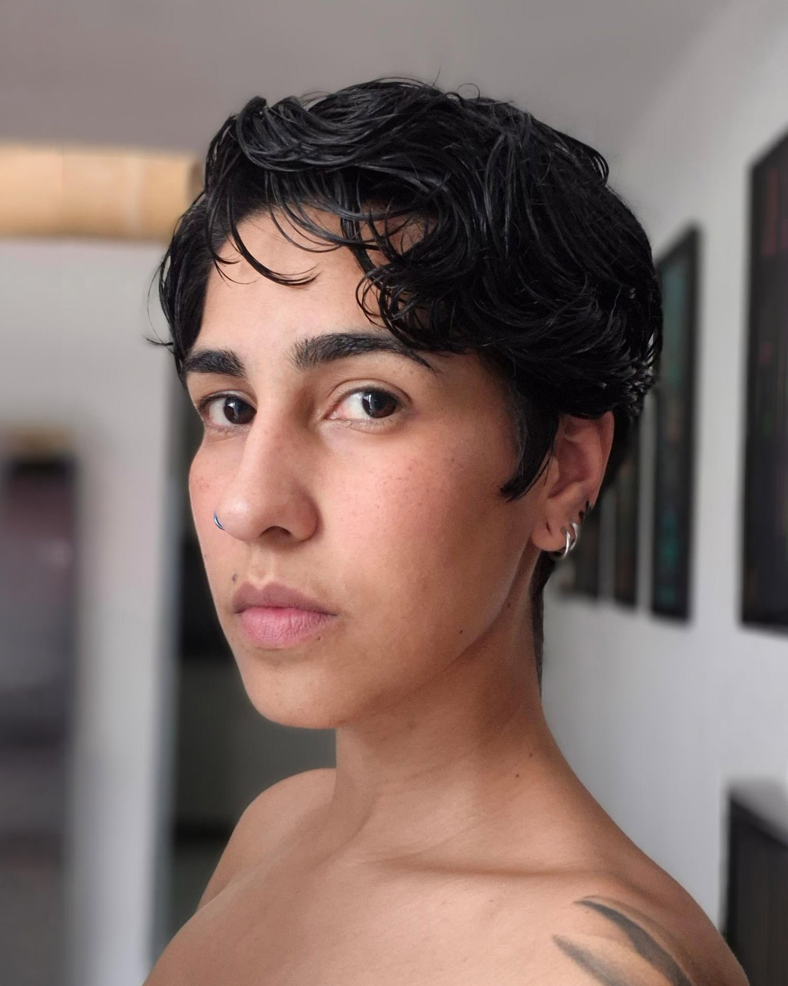 Close-up portrait with short, tousled dark hair